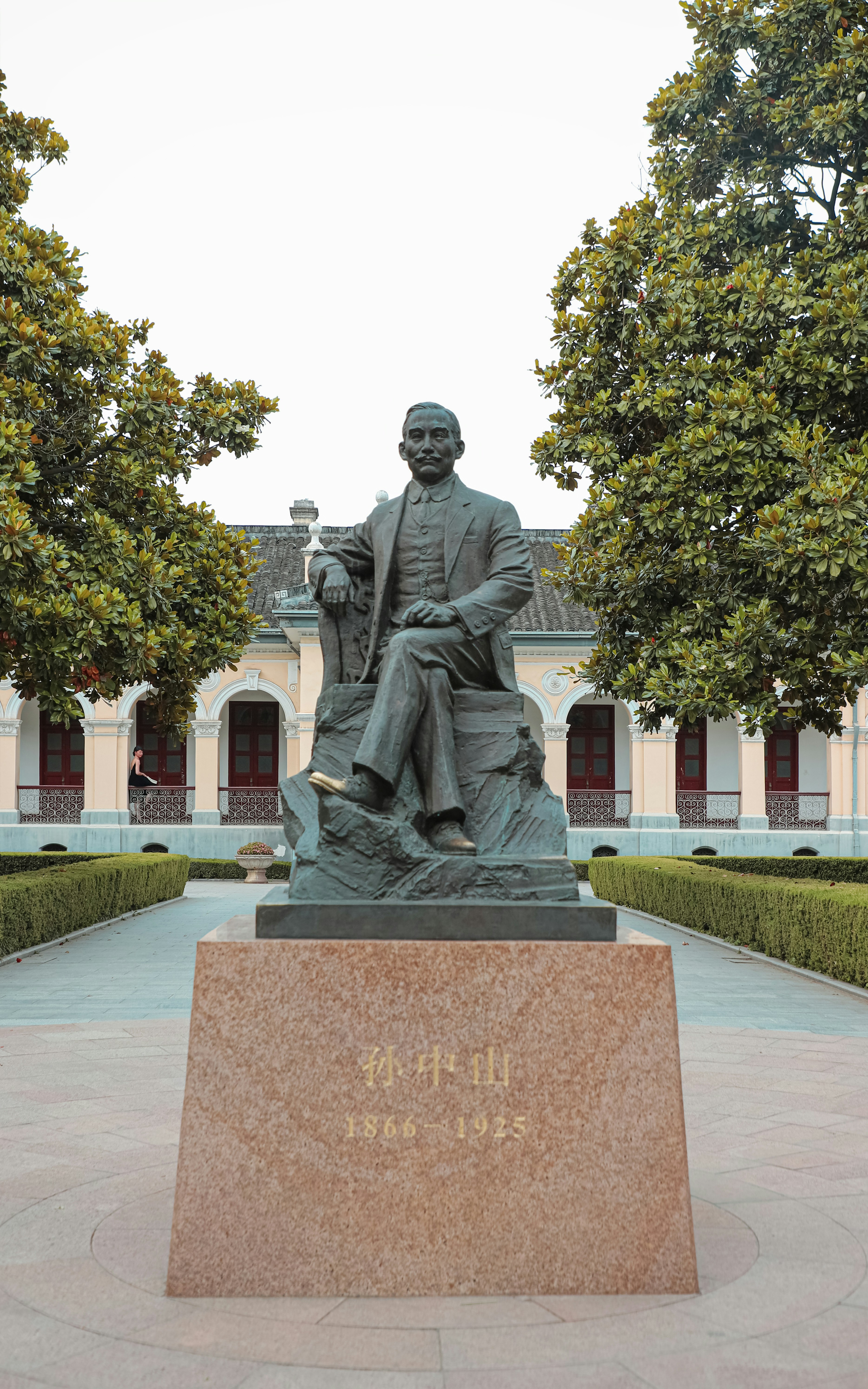a statue of a man sitting on a bench