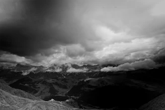 A dramatic landscape with stormy skies and rugged terrain, shot in rich contrast.