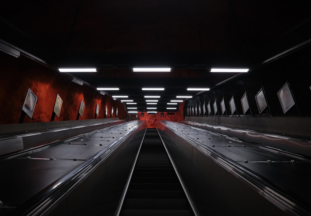 an empty subway station with empty escalators