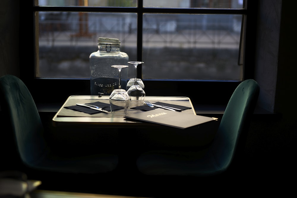 a table with a bottle and some glasses on it