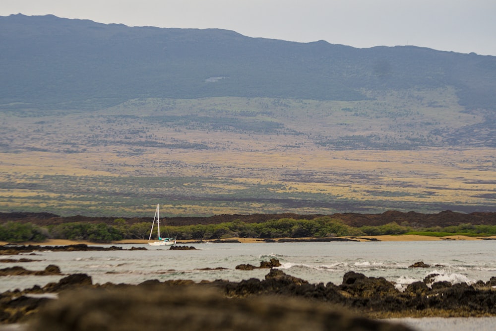 a body of water with a mountain in the background