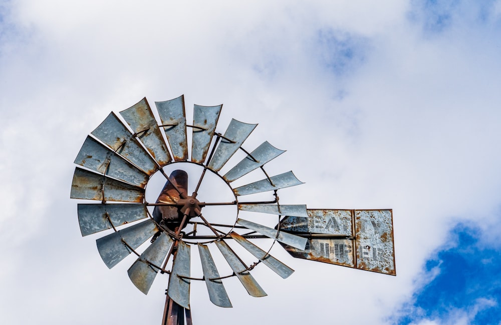 an old rusty windmill on a cloudy day