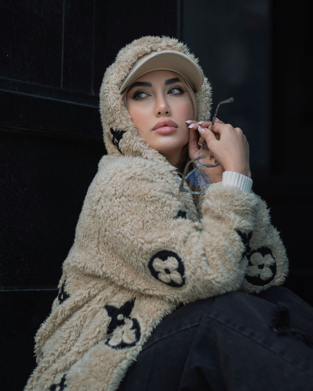 a woman in a furry coat smoking a cigarette