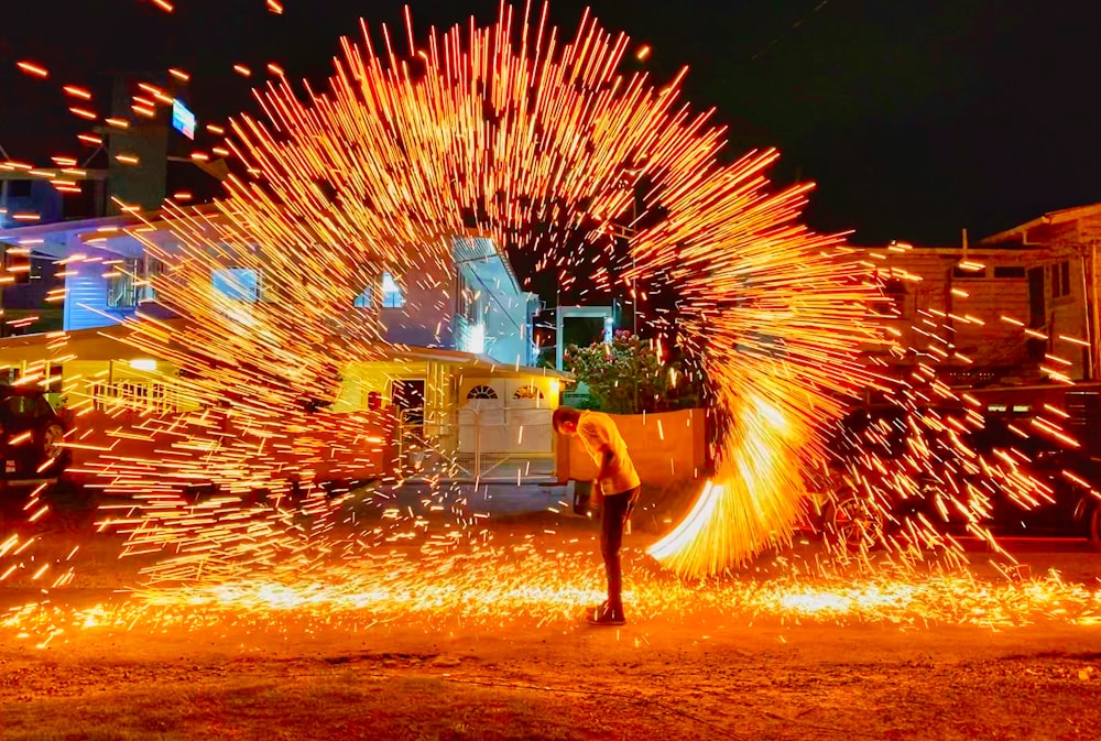 a man standing in front of a firework display