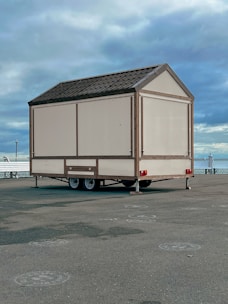A mobile cabin on wheels, ready for quick relocation, painted in karfanspace's signature orange.