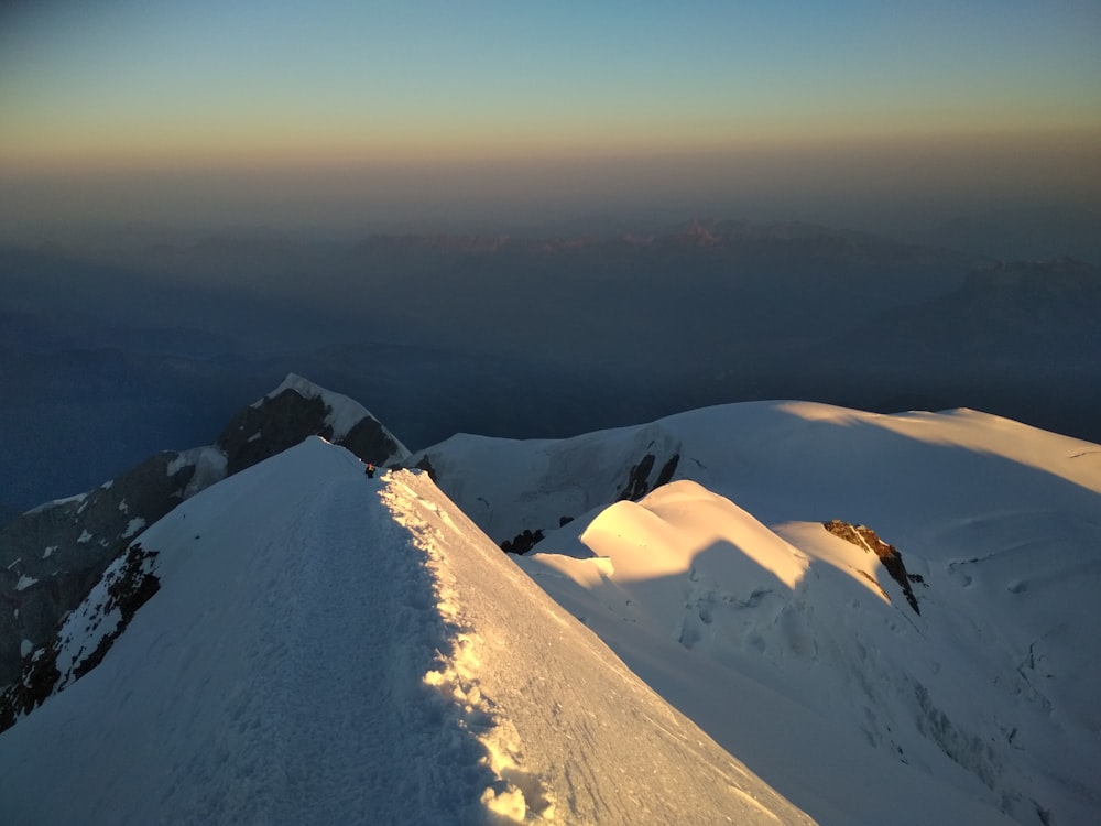 a person standing on top of a snow covered mountain