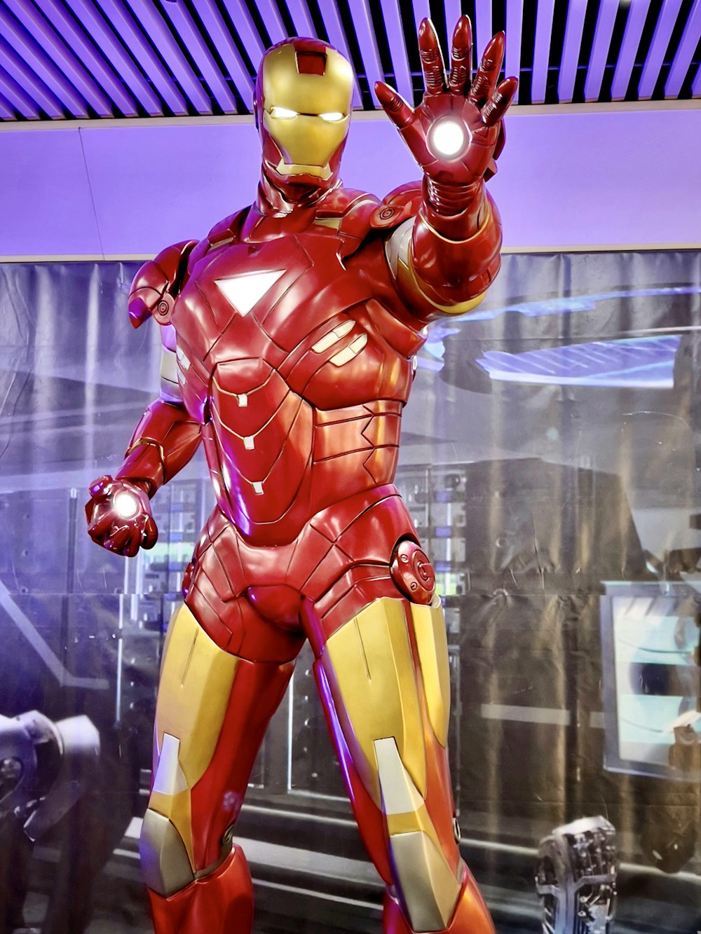 a statue of iron man is displayed in a museum