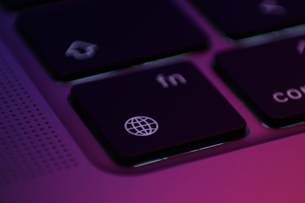 a close up of a keyboard with a purple background