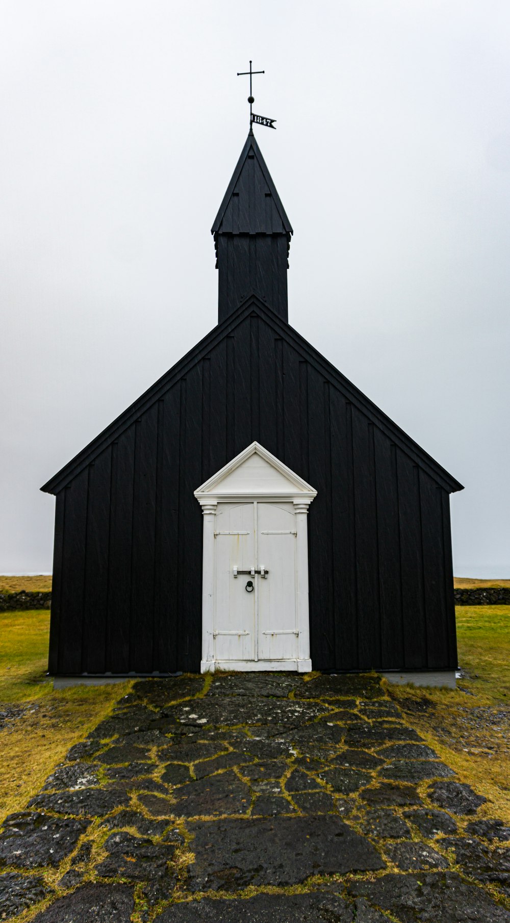 a black and white church with a steeple