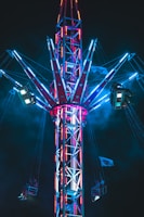 a ferris wheel is lit up at night