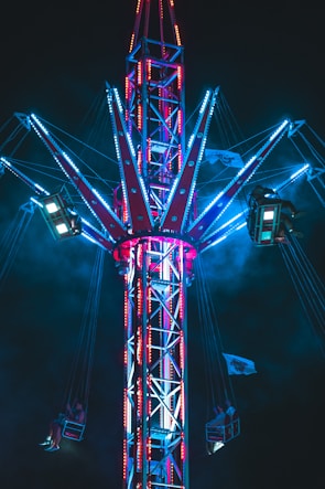 a ferris wheel is lit up at night