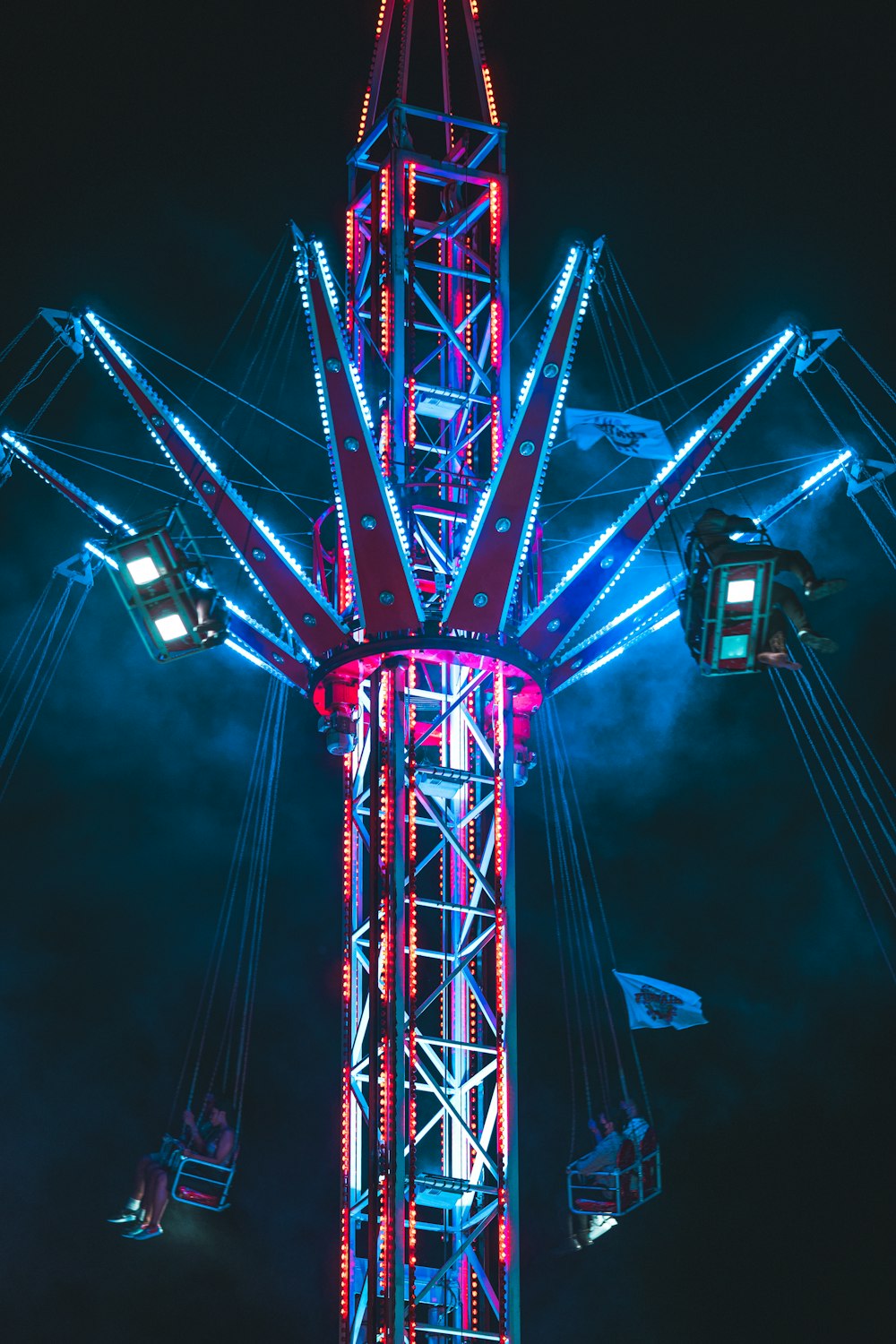 a ferris wheel is lit up at night