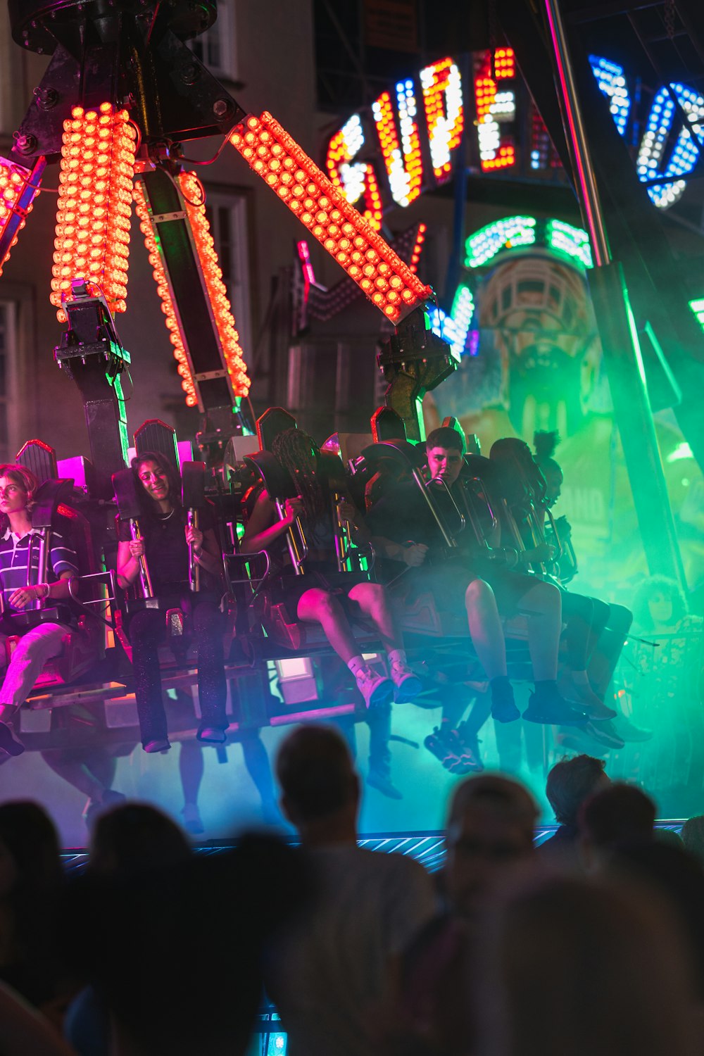 a group of people on a stage with neon lights