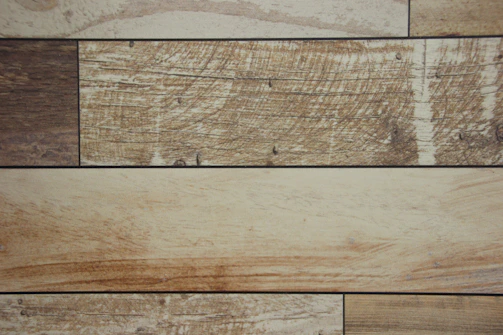 Various wooden planks showcasing different grains and textures, arranged artfully.