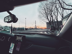 Night view of a VTC car with illuminated city streets of Bezons in the background.