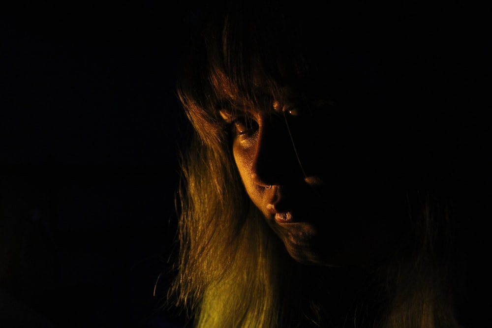 a woman in the dark with long hair