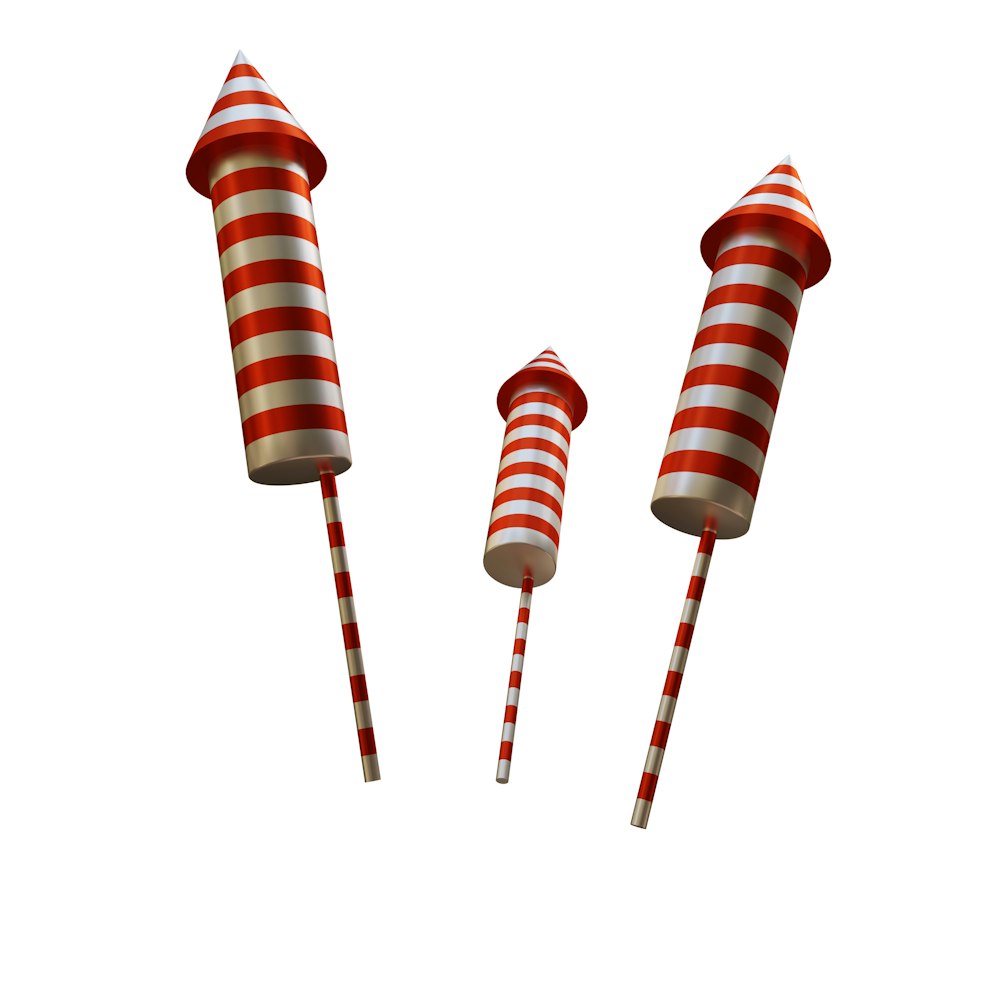three red and white striped candy canes on a white background