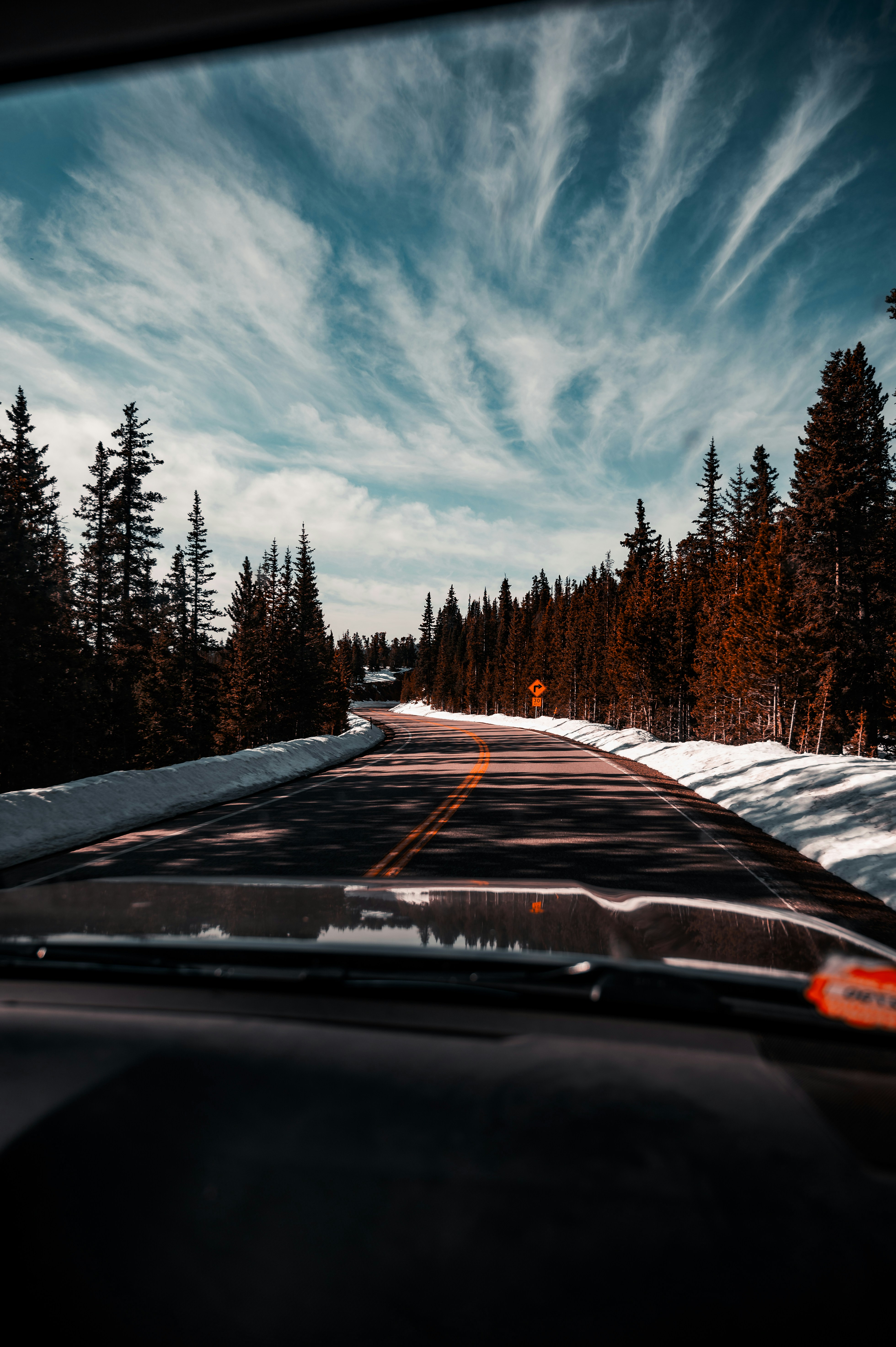 a car driving down a snow covered road