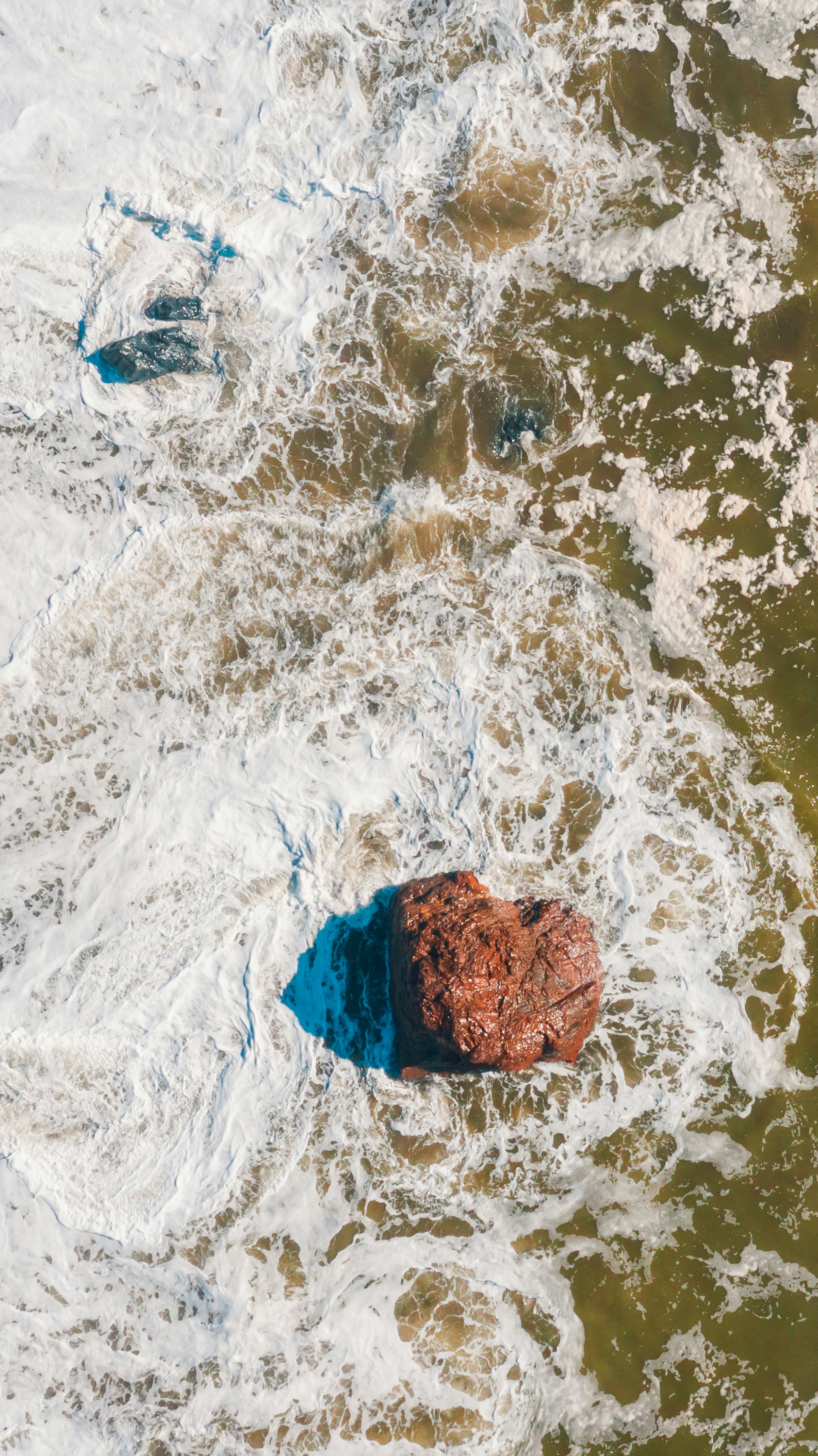 a rock in the middle of a body of water