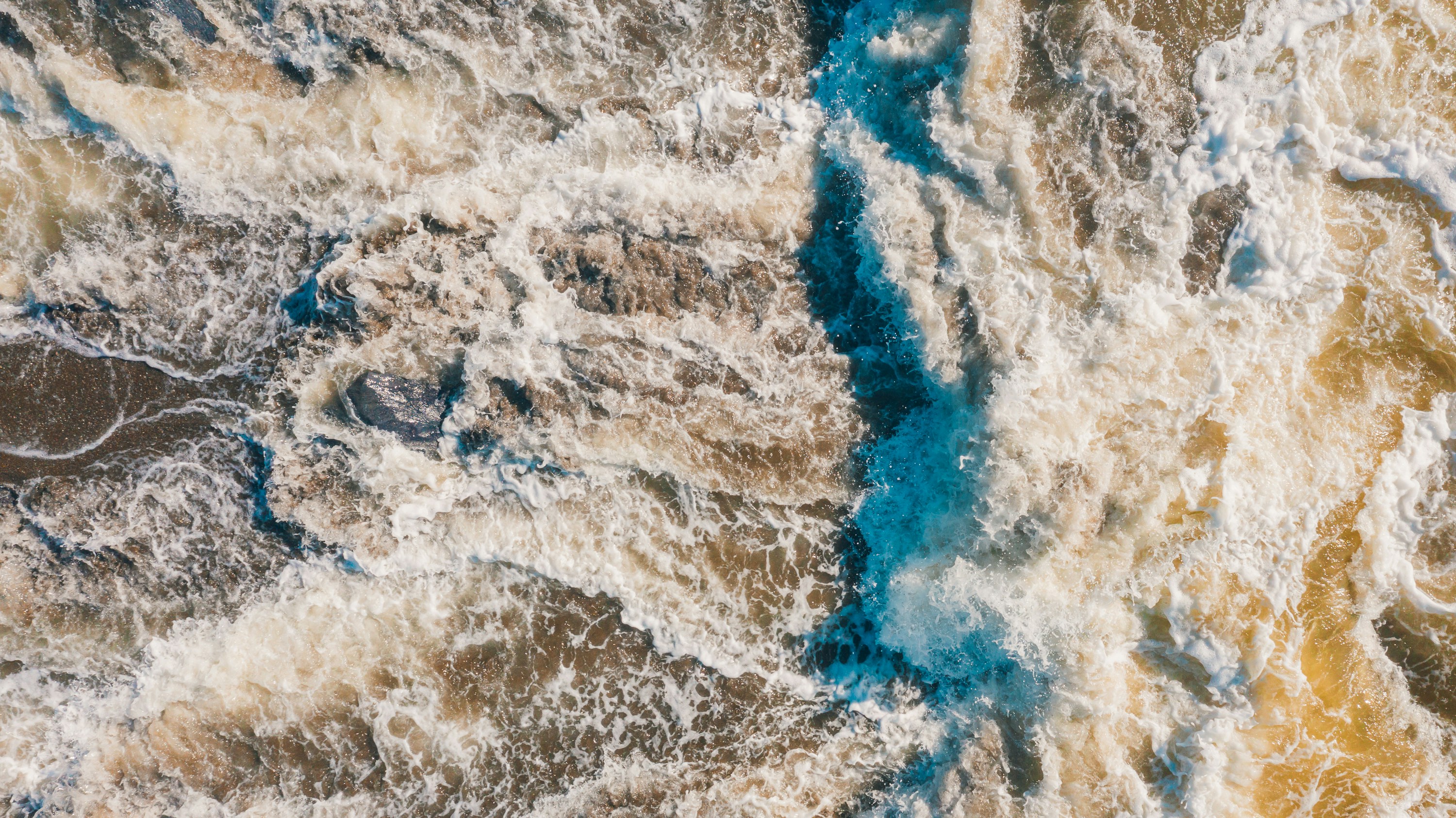 an aerial view of the ocean with waves