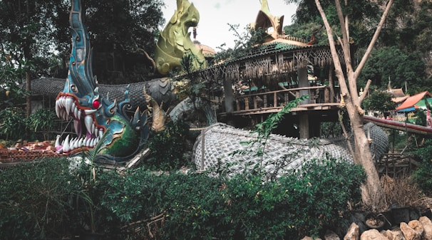 An intense dragon curled around ancient ruins, flames glowing softly in the twilight.