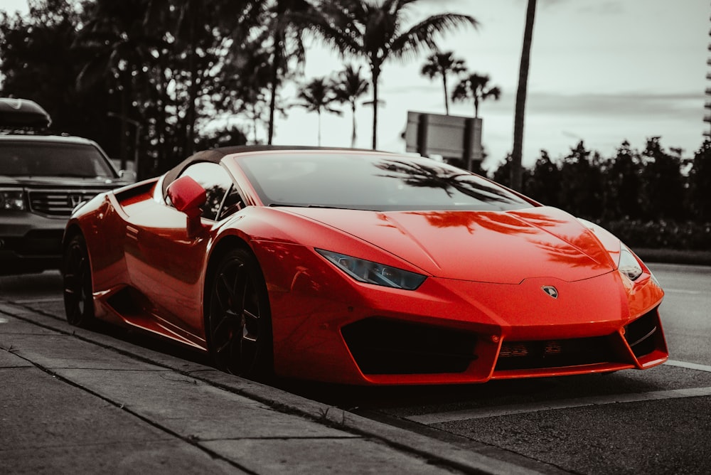 a red sports car parked on the side of the road