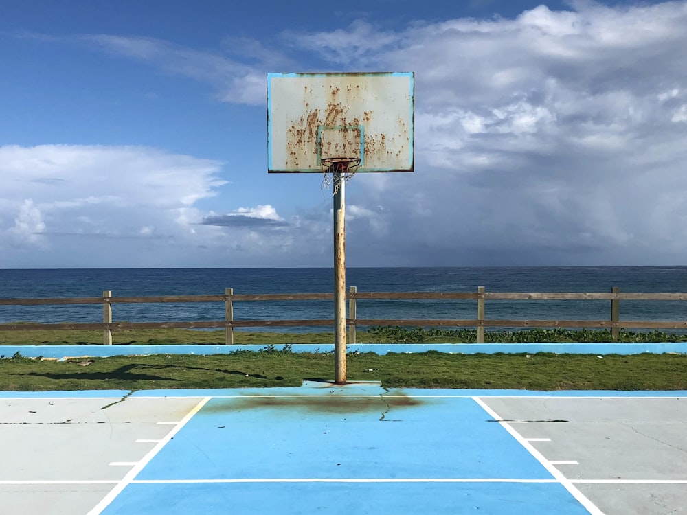 a basketball court in front of a body of water