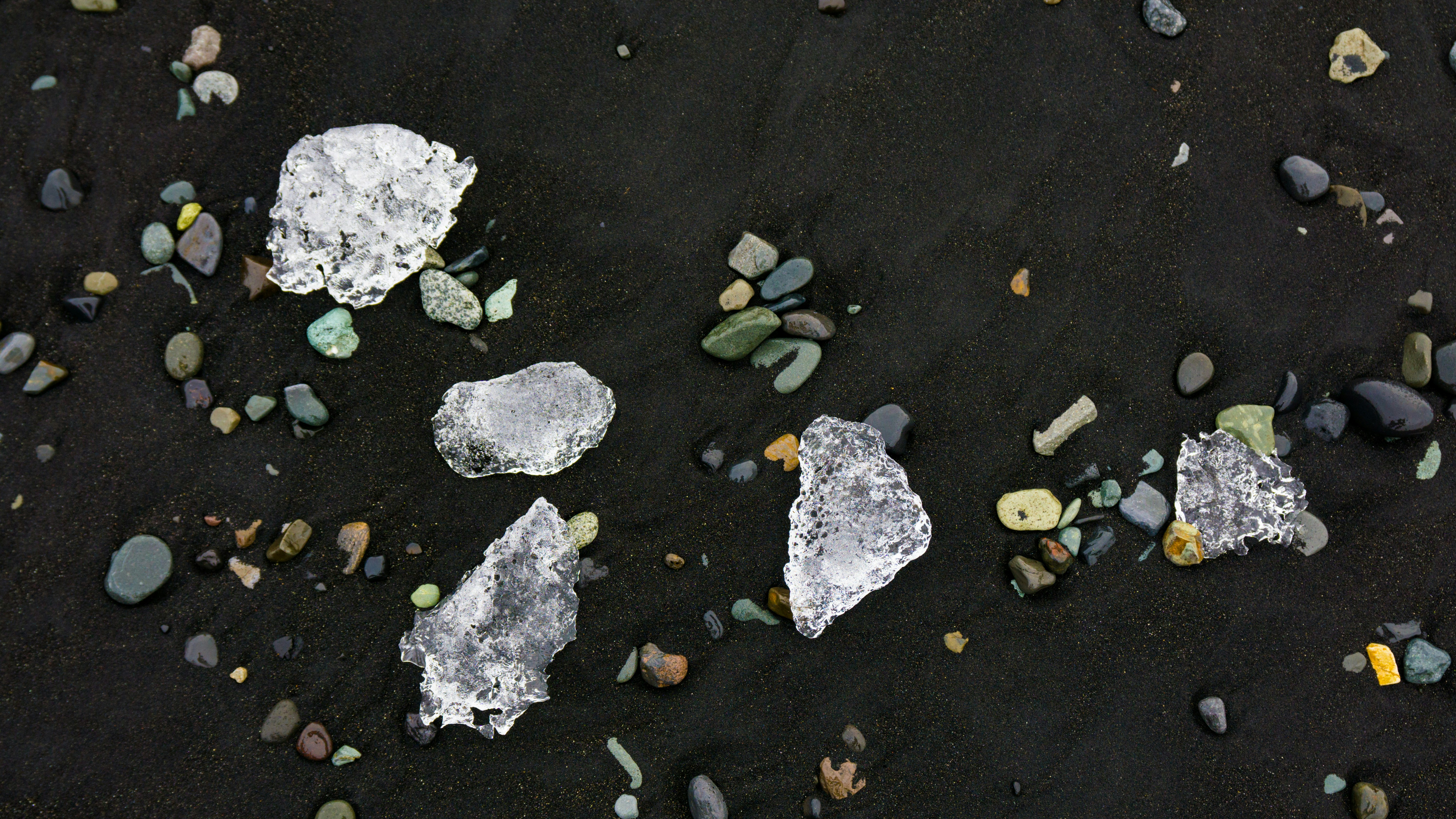 some rocks and gravel on a black surface