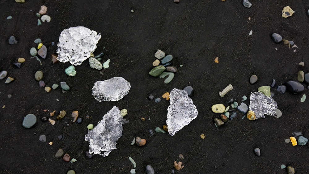 some rocks and gravel on a black surface