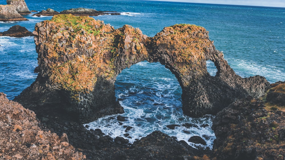 a rock formation in the middle of a body of water