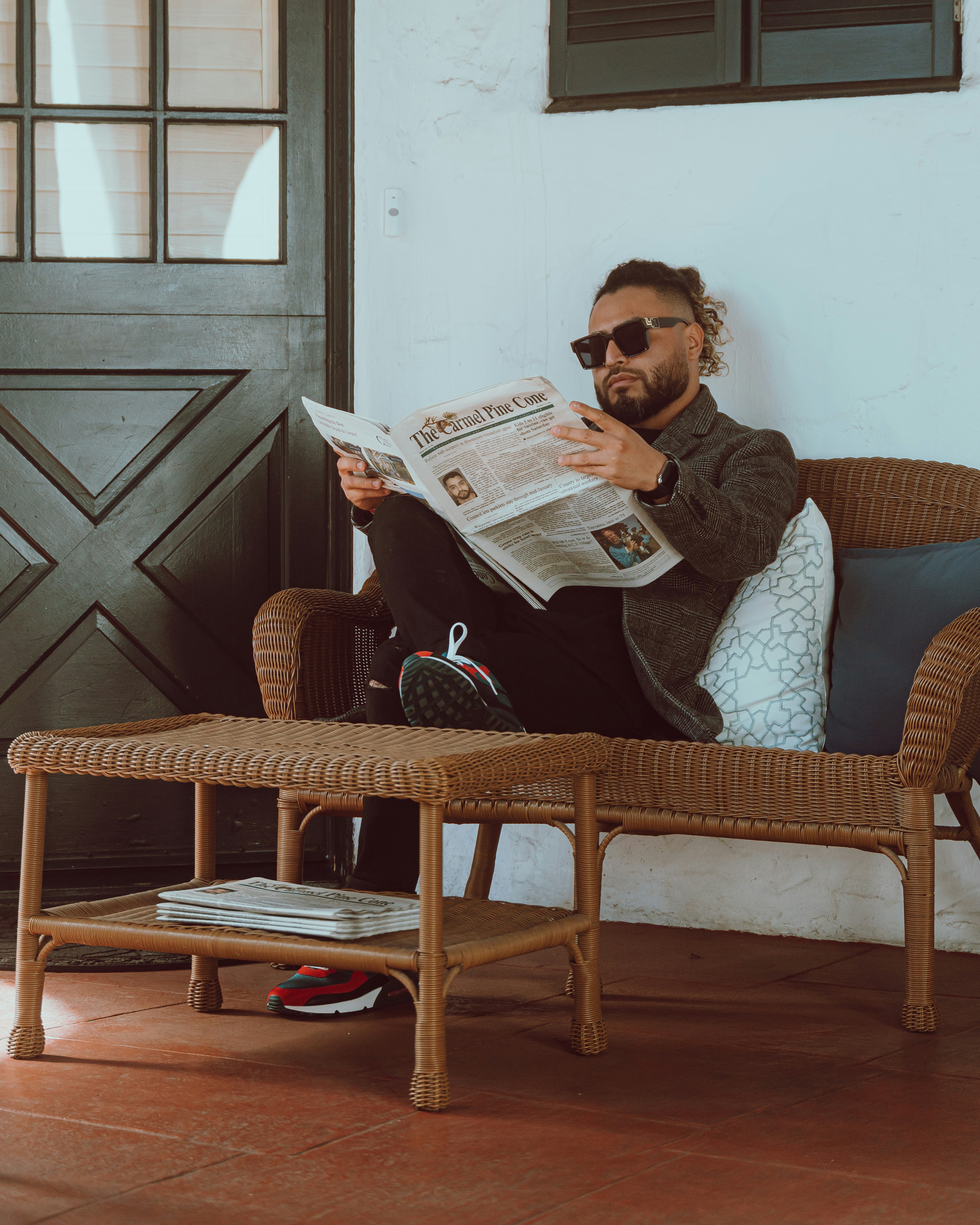 A man sitting in a chair reading a newspaper