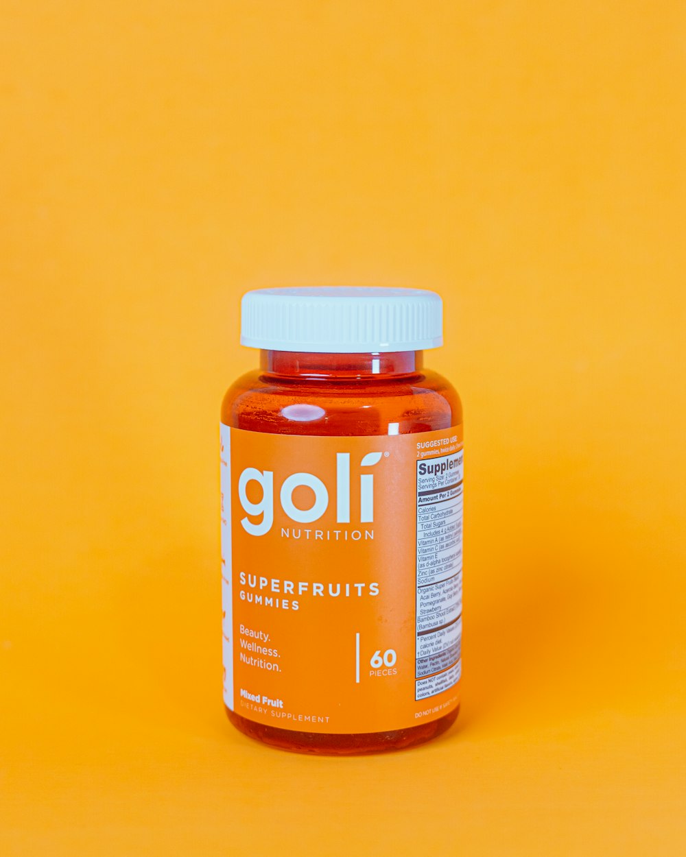 a bottle of golf nutrition superfruits on a yellow background