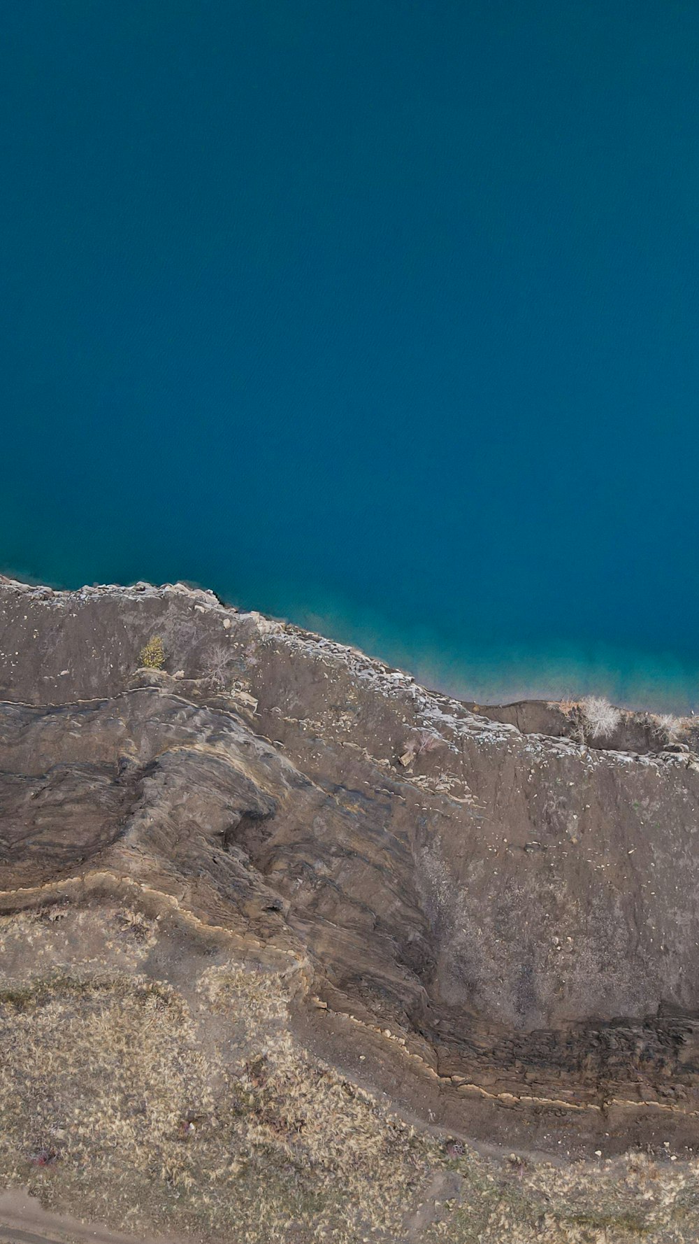 an aerial view of a mountain and a body of water