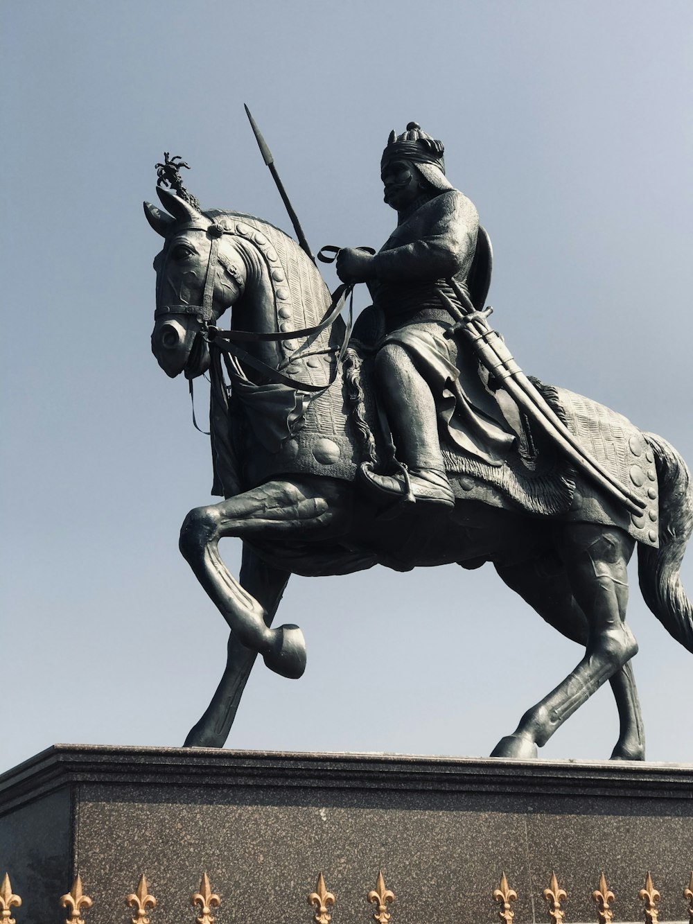 a statue of a person riding a horse