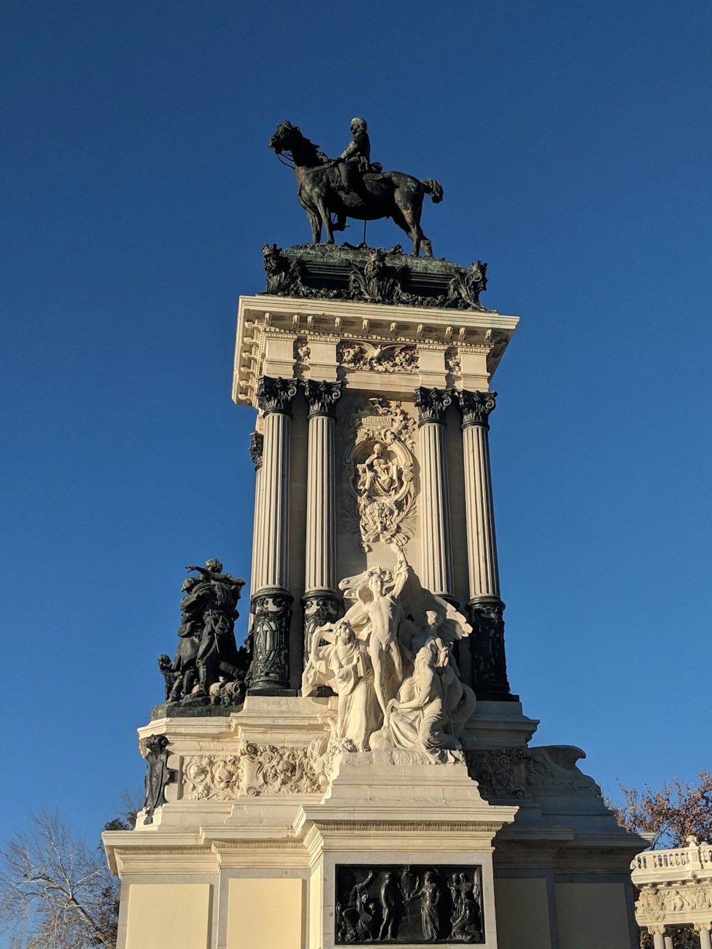 a statue of a man on a horse on top of a building