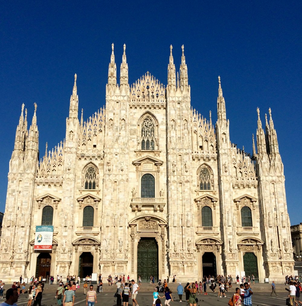 a group of people standing in front of a large building