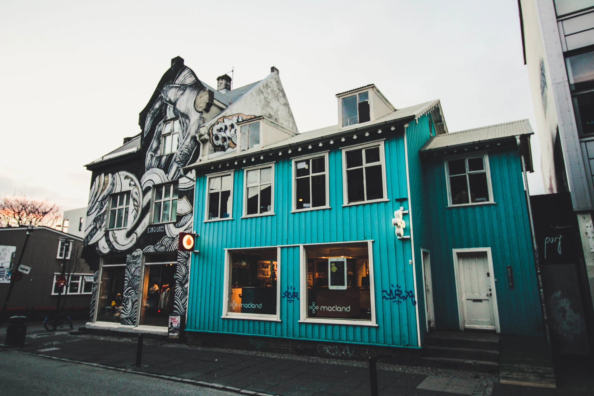 a blue building with a mural on the side of it