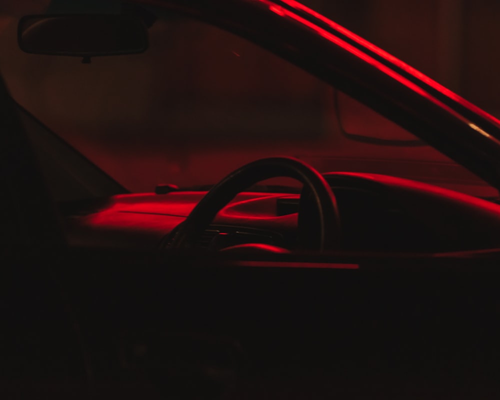 the interior of a car with a red light on