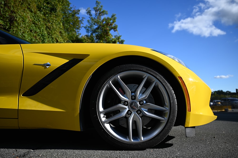 a yellow sports car parked in a parking lot