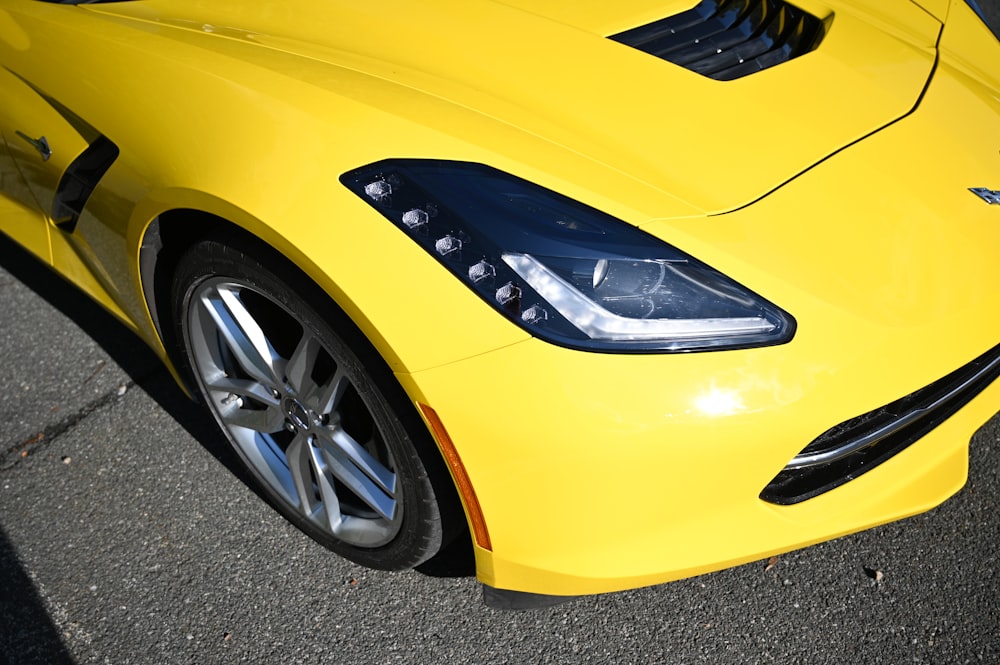 a yellow sports car parked in a parking lot