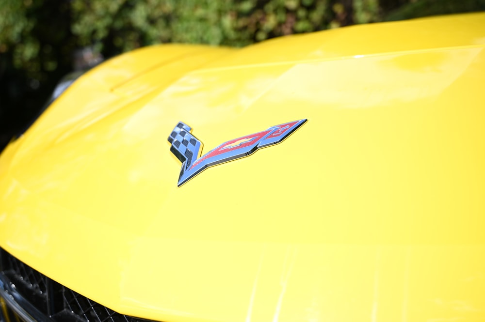 a close up of the hood of a yellow sports car