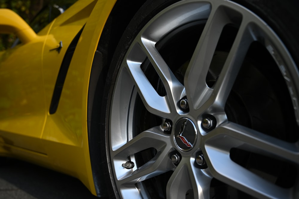 a yellow sports car parked on the side of the road