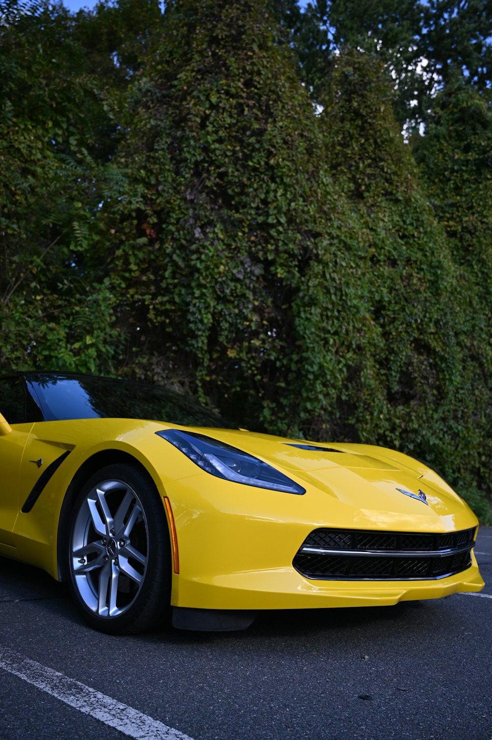 a yellow sports car parked in a parking lot