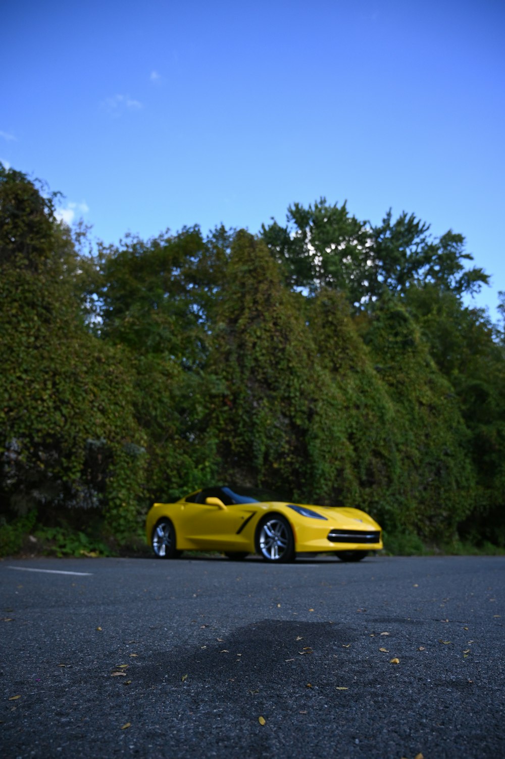 a yellow sports car parked on the side of the road