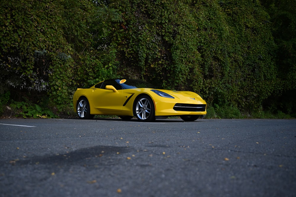 a yellow sports car parked on the side of the road