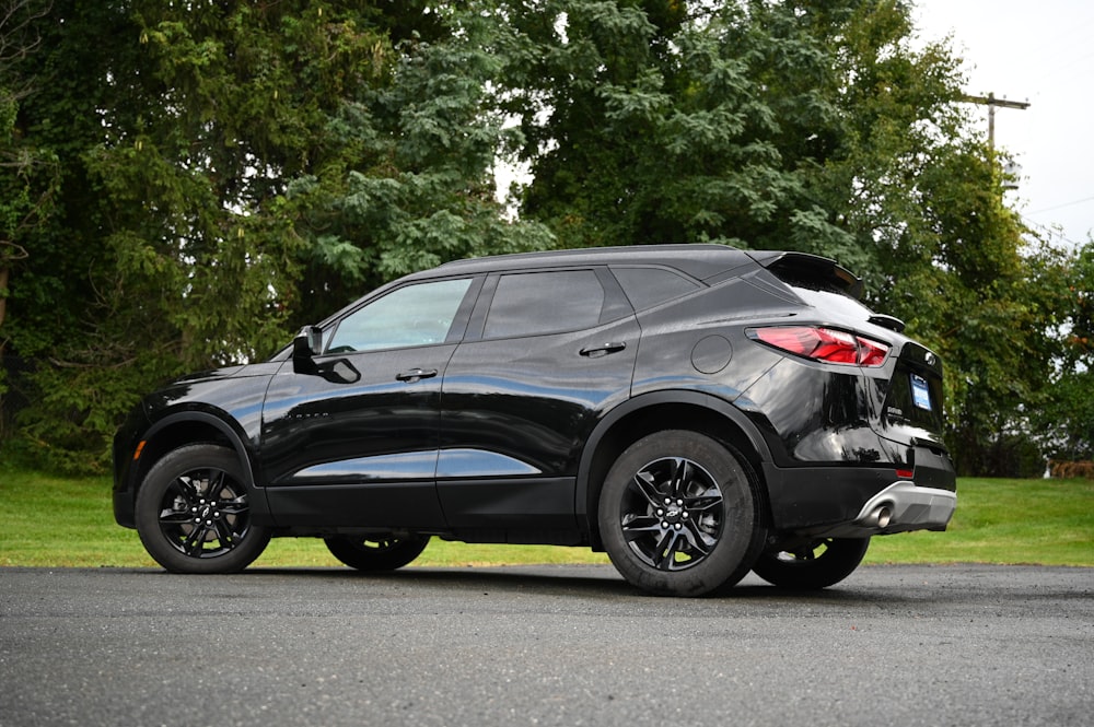 a black suv parked on the side of the road