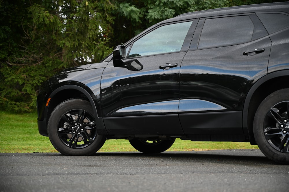 a black suv parked on the side of the road