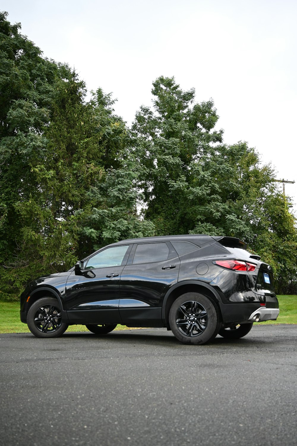 a black suv parked on the side of the road