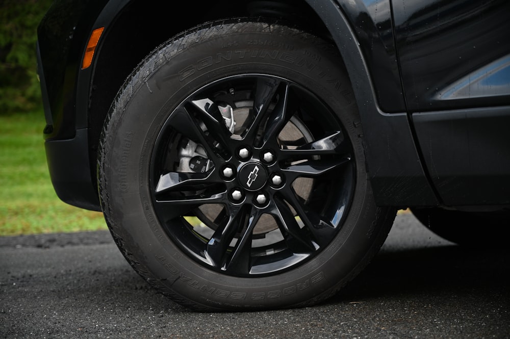 a close up of a tire on a black truck