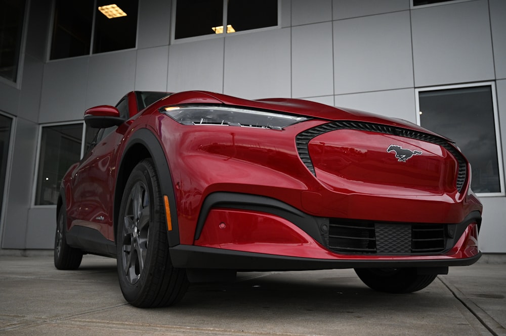 a red sports car parked in front of a building